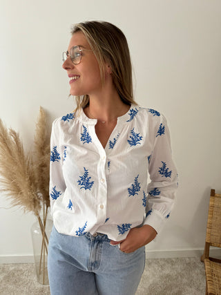 Blue leaves white blouse