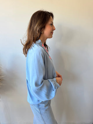 Pink detail blue blouse