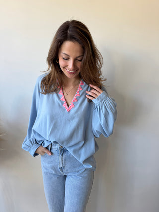 Pink detail blue blouse