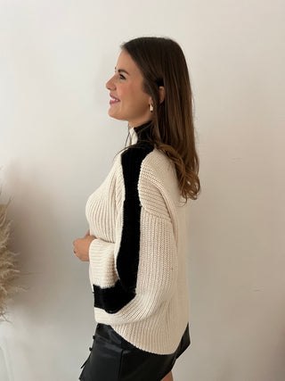 Black sleeves white knit